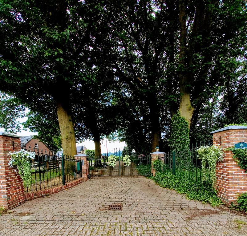 ogrodzenie z bramą przed drzewami w obiekcie mooie familie groepsaccomodatie aan de bosrand w mieście Overloon