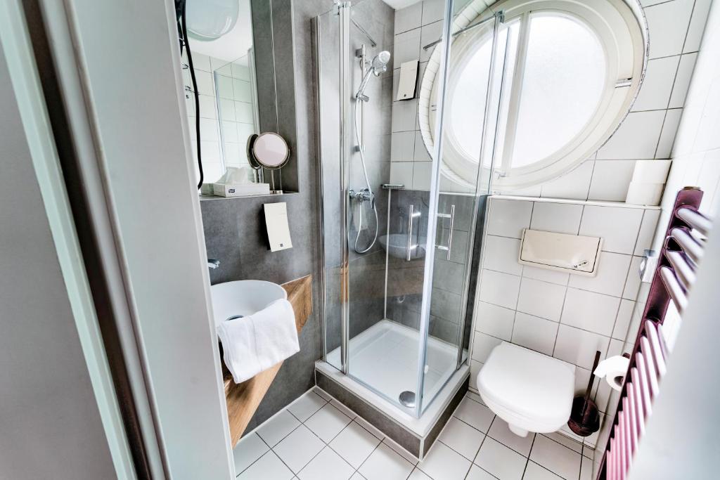 a bathroom with a shower and a sink at Hotel Tanne in Saalfeld