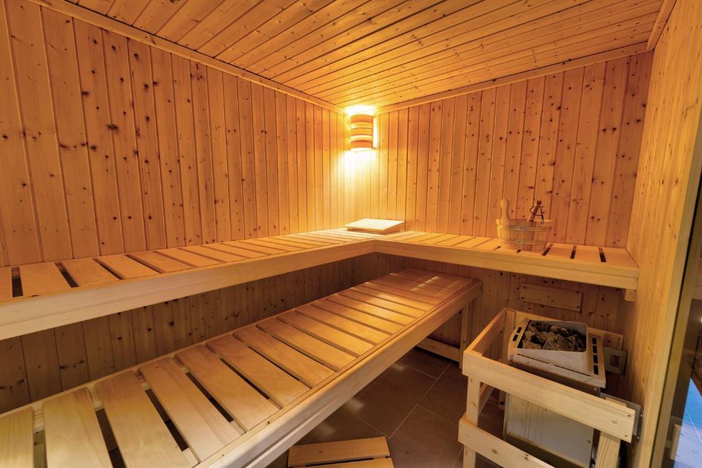 a wooden sauna with a bench in it at Hotel Tanne in Saalfeld