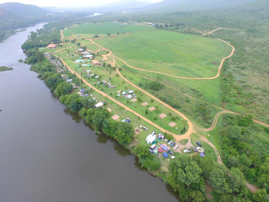 an aerial view of a river with a group of tents at Riverrun Resort Farmhouse in Tygerfontein