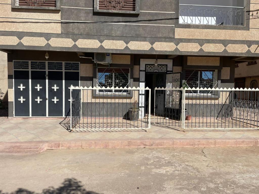 a building with a gate in front of a building at Luxurious appartement in Oujda
