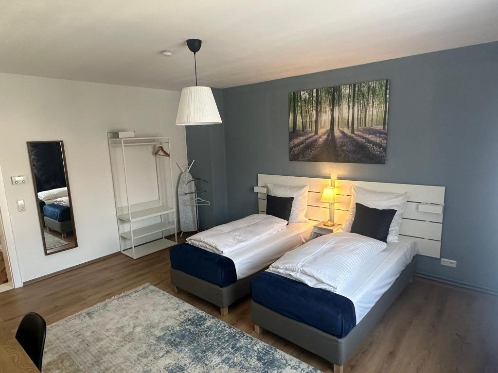 1 dormitorio con 2 camas y un cuadro en la pared en Hami Apartments Hannover en Hannover