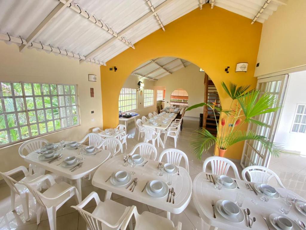 a dining room with white tables and white chairs at Finca Andalucia con Piscina en Mesitas in El Colegio
