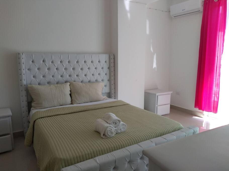 a bedroom with a bed with a towel on it at Boca del mar, apartamento 207/206 in Cuevas
