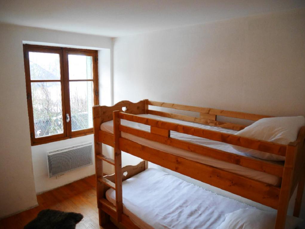 Chalet de Pampo في فوياني: غرفة نوم بسريرين بطابقين ونافذة