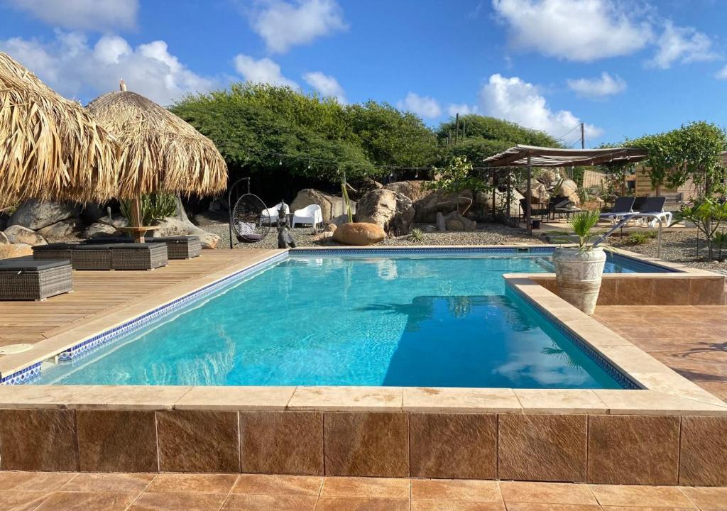 a swimming pool in a resort with at Pura Vida Aruba Appartement Palma in Noord