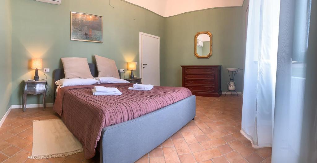 a bedroom with a large bed with two towels on it at Casa in Centro. Nel cuore della città. in Chieti