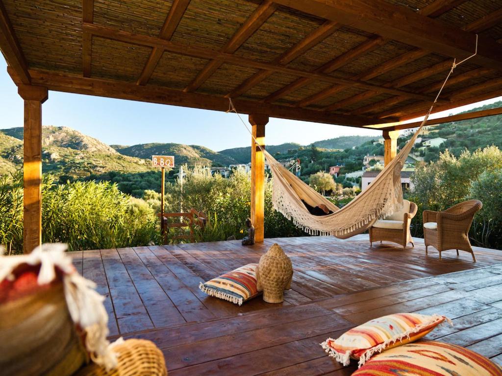 a hammock on a deck with a view of mountains at Smart Appart Sweet Sardinia in Murta Maria