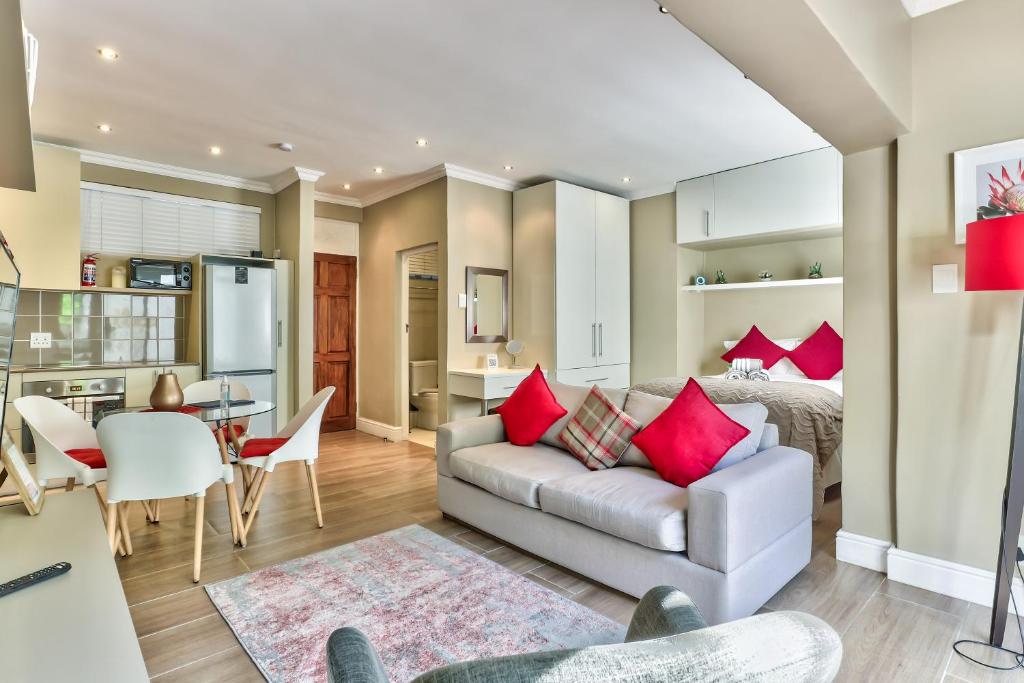uma sala de estar com um sofá e uma sala de jantar em Fairmile on Main na Cidade do Cabo