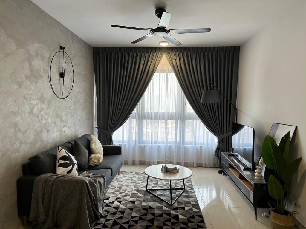 a living room with a couch and a ceiling fan at Best for Family KLCC Pavillion Sunway Velocity MRT in Kuala Lumpur