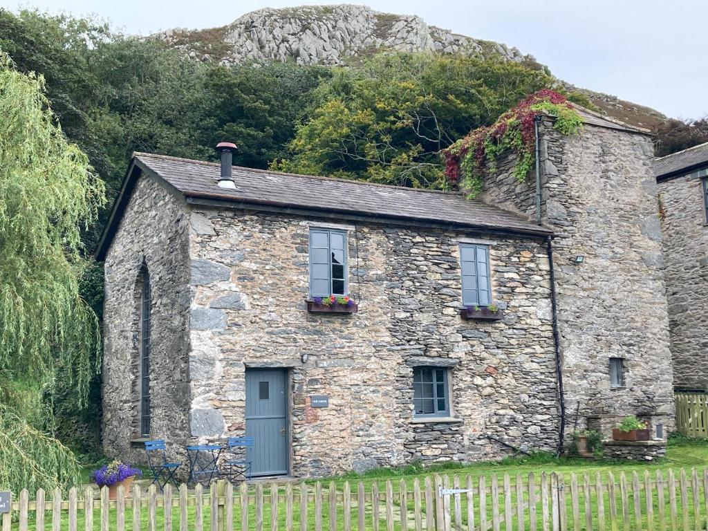 a stone house with a fence in front of it at The Chapel in Millom