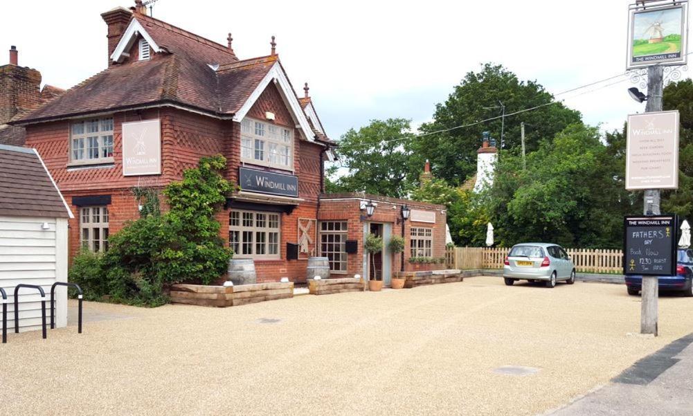 a car parked in front of a brick building at The Windmill Inn in Horsham