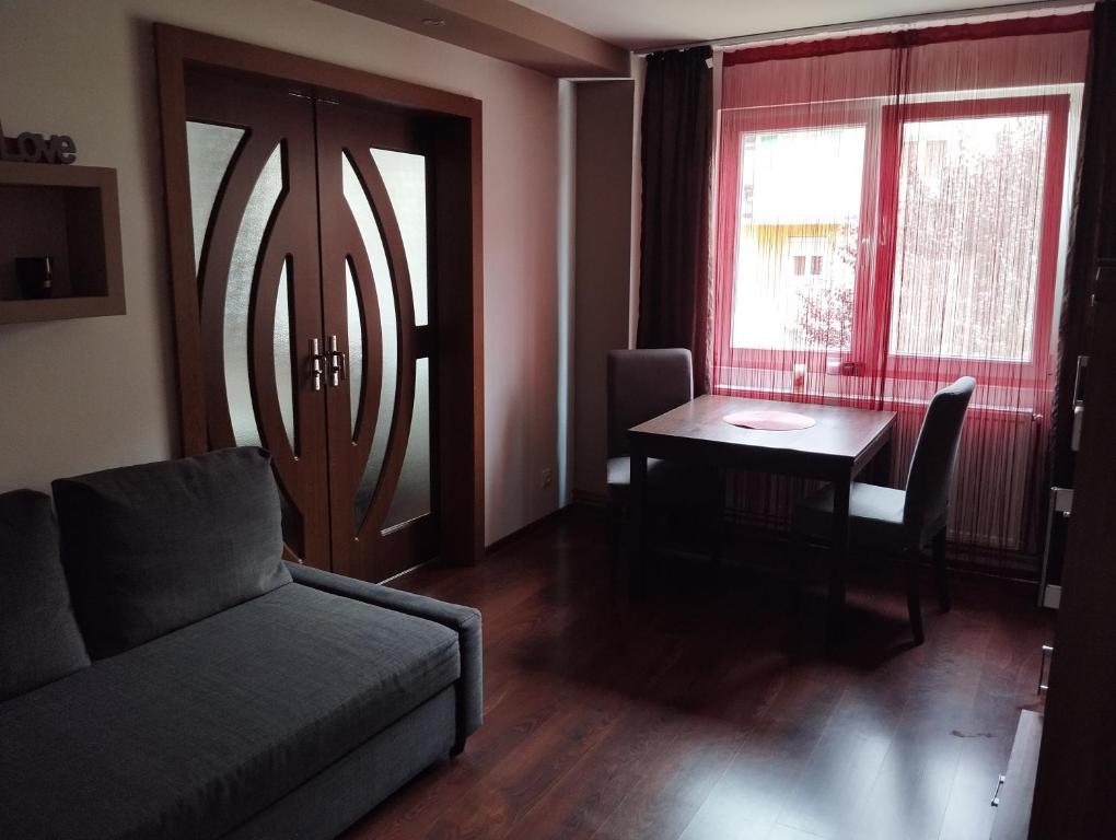 A&D في ريشيتسا: غرفة معيشة مع أريكة وطاولة ونافذة