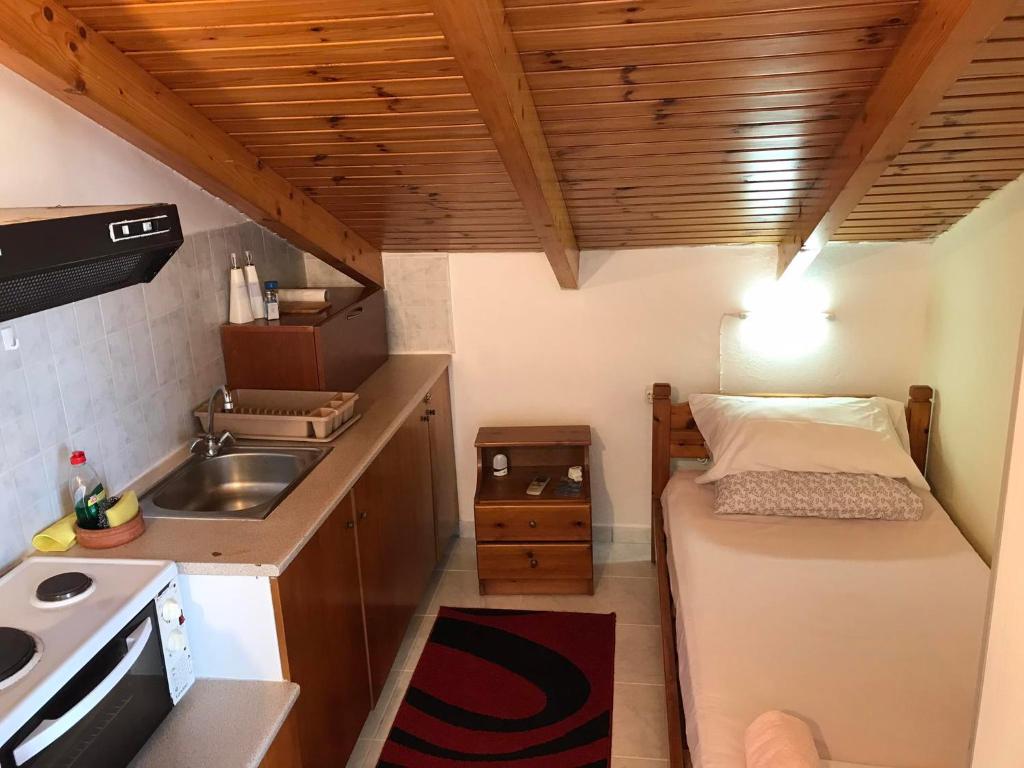 a small kitchen with a bed and a sink at Ion Apartments Messolonghi Single Bed Room Mountain View Loft in Missolonghi