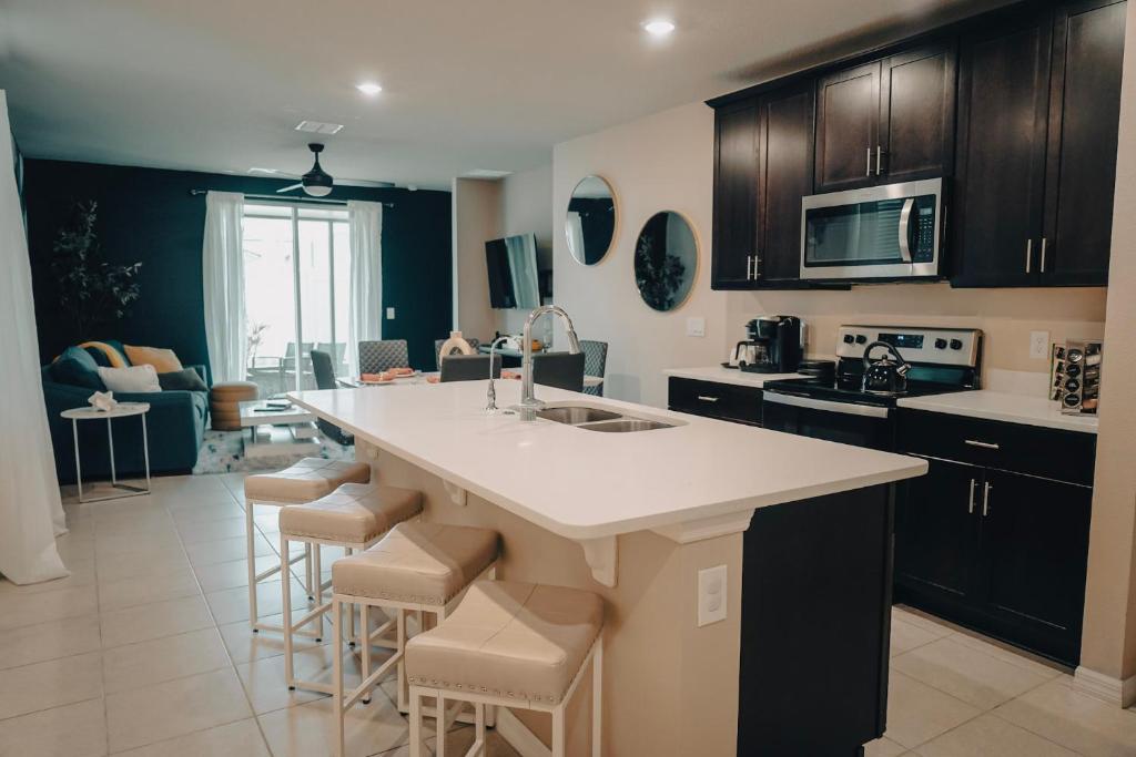 a kitchen with a large island in the middle of a room at J's Family Vacation Low Maid Fee in Davenport