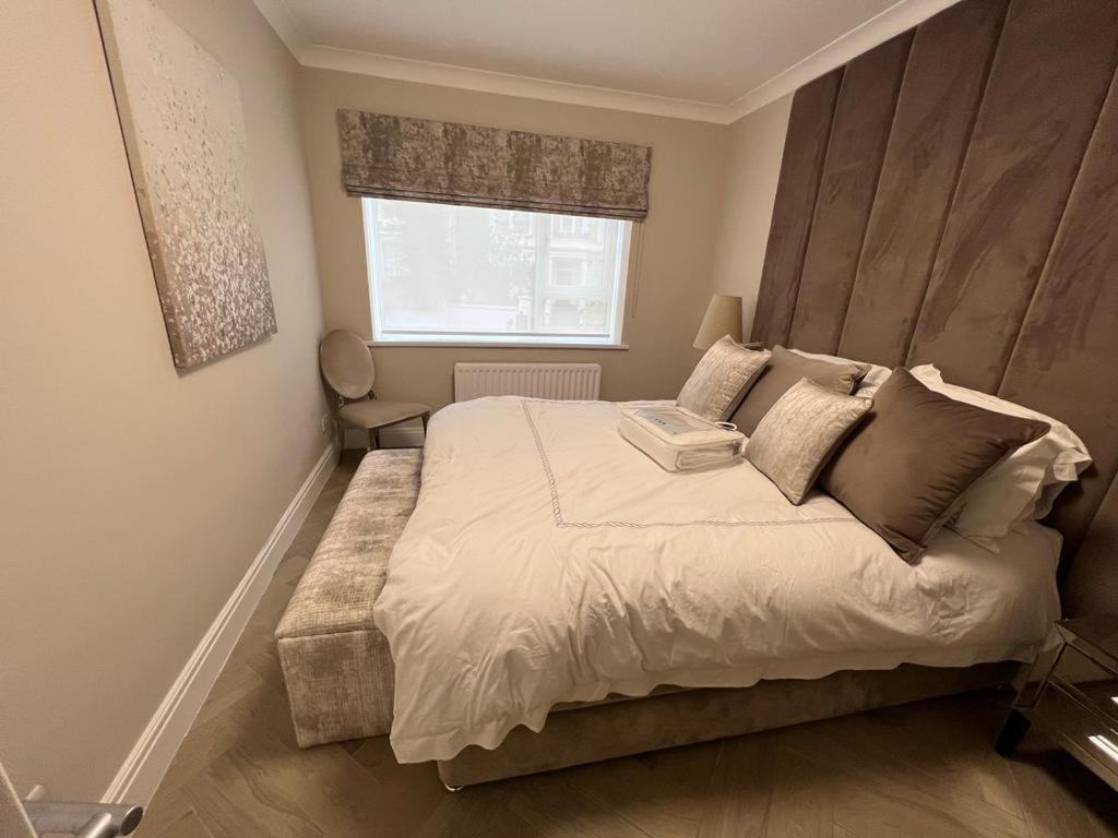 sypialnia z dużym łóżkiem i oknem w obiekcie Luxurious apartment in Central London w Londynie