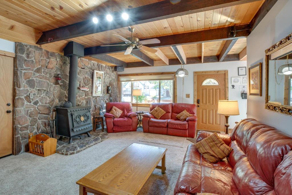 a living room with a couch and a wood stove at 11 Mi to Ski Resorts! Lake Tahoe Gem with Pool Table in South Lake Tahoe