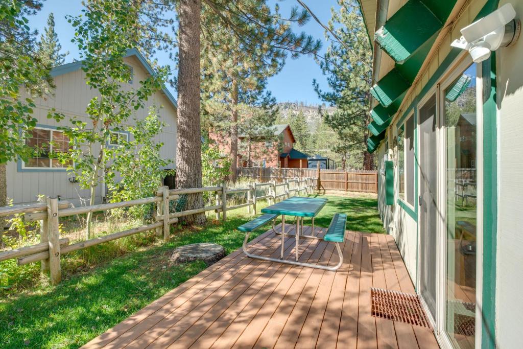 a patio with a blue table and chairs on it at Rustic Lake Tahoe Cabin 2 Blocks to Truckee River in South Lake Tahoe