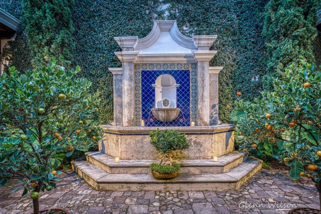 a bird bath in a garden with oranges at San Rafael Hotel in Antigua Guatemala