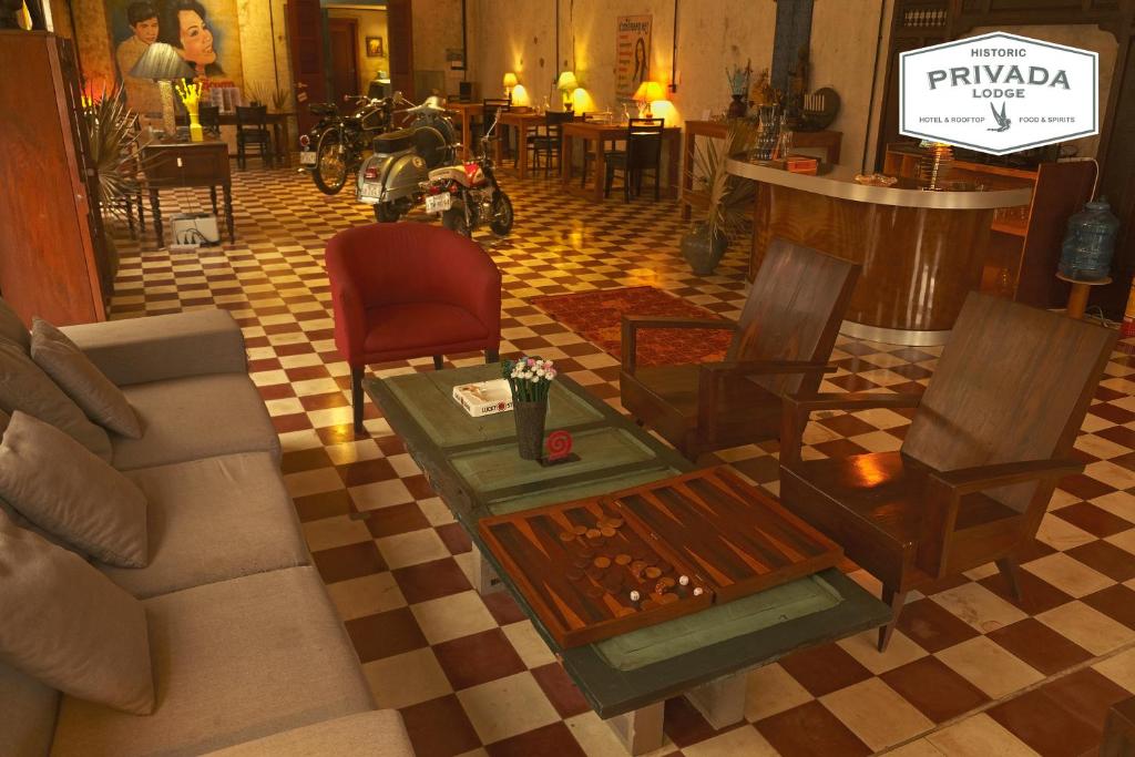- un salon avec un canapé, une table et des chaises dans l'établissement PRIVADA LODGE, à Kratie