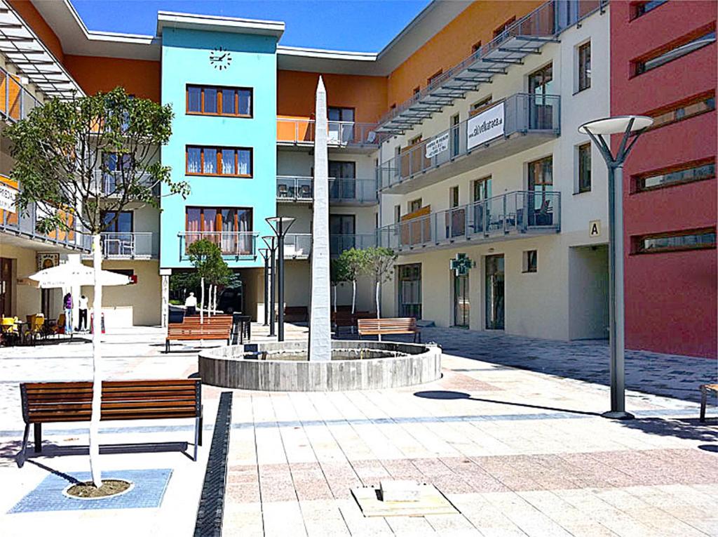 a courtyard with benches in front of a building at Apartmán Oščadnica in Oščadnica