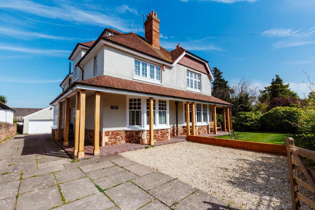 an exterior view of a house with a driveway at Westholme Lodge in Minehead