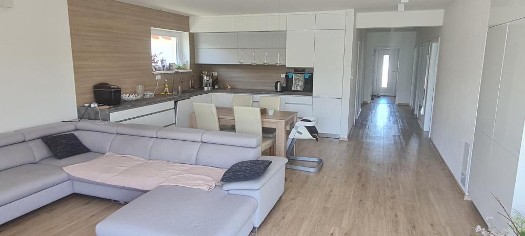 a living room with a couch and a kitchen at Villa Senec Gardens in Senec