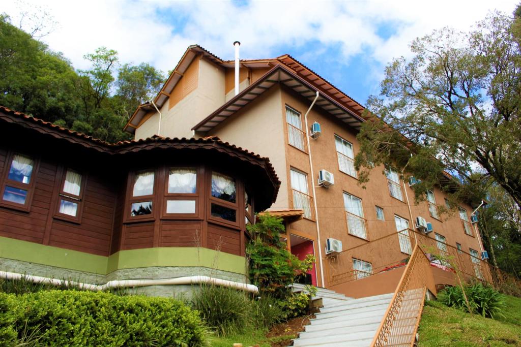 a building with stairs in front of it at Pousada Essência Serrana Gramado in Gramado