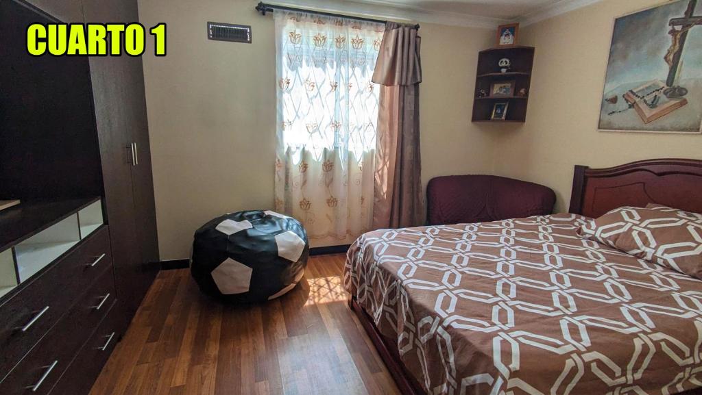 een slaapkamer met een bed en een raam bij Freddy Departamento amoblado in Cuenca