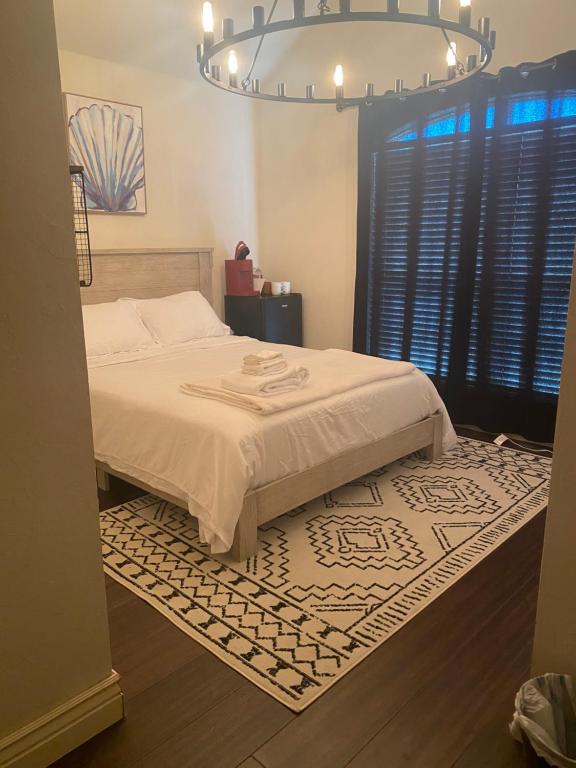 a bedroom with a bed with a rug and a chandelier at Field Stone in Oklahoma City