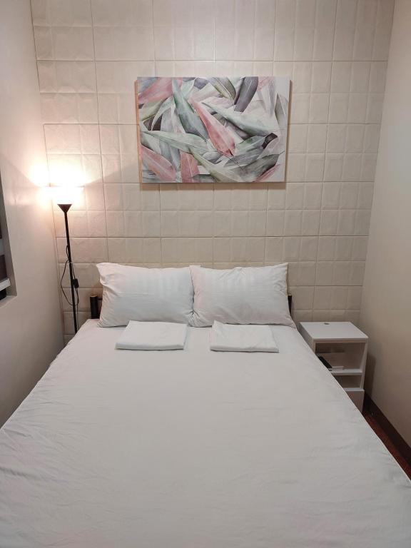 Postel nebo postele na pokoji v ubytování Apartelle near Philippine Arena