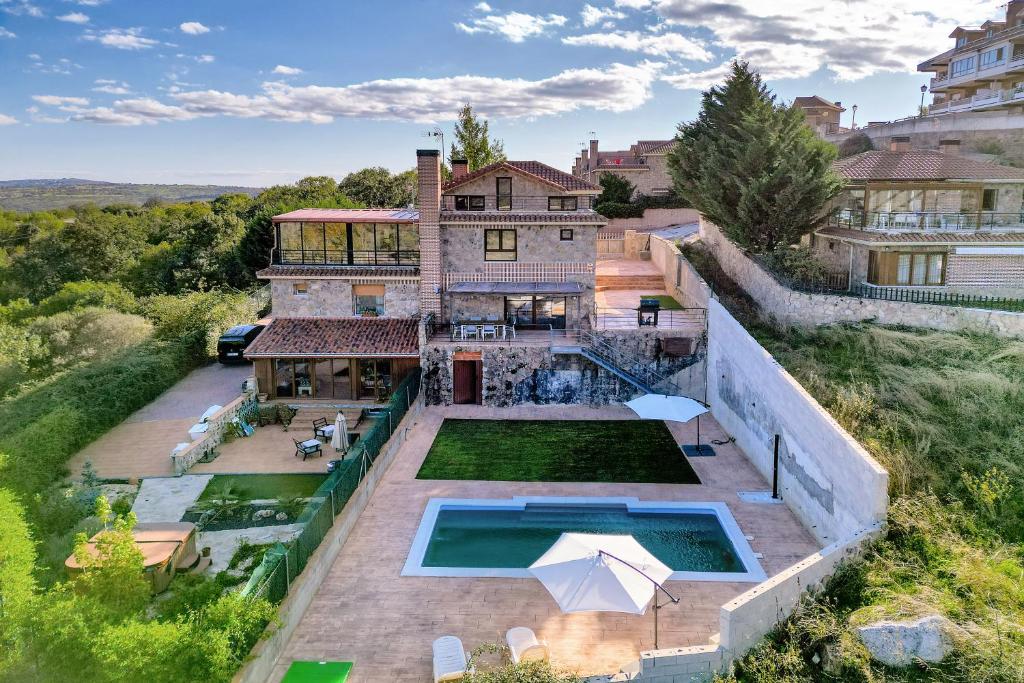 an aerial view of a house with a swimming pool at Luxe Villa, Pool, Mountain views, BBQ, Sky, in Miraflores de la Sierra