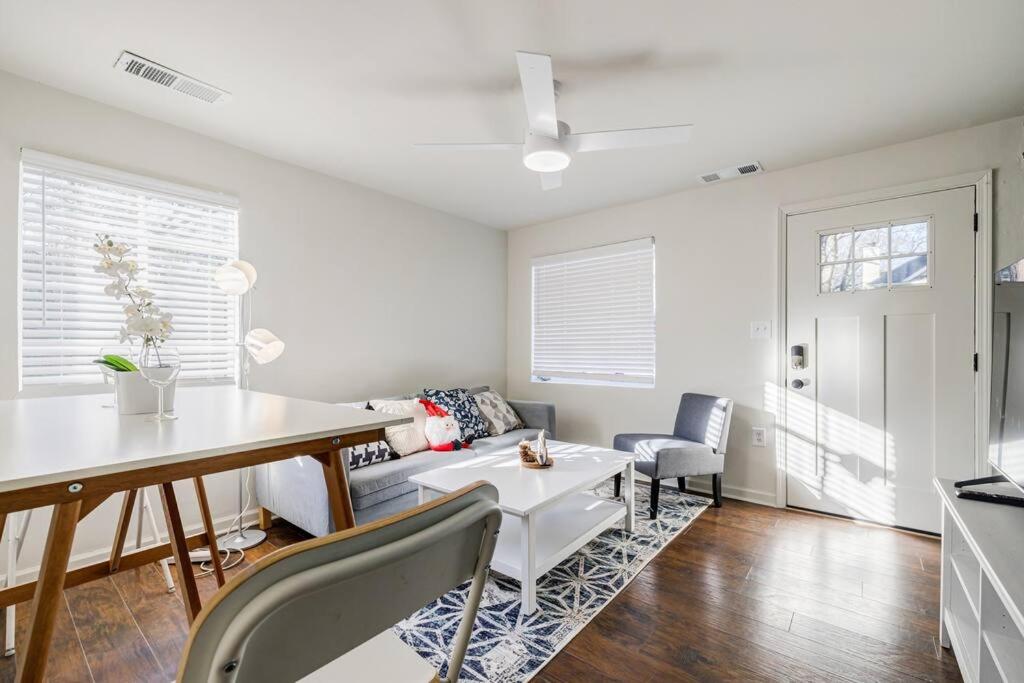 a white living room with a table and chairs at 5min-Grant park with Fenced Yard, Parking and Pet Friendly in Atlanta