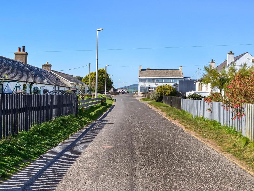 an empty street with houses and a fence at Lakeland View 69 - Uk44196 in Mainsriddle