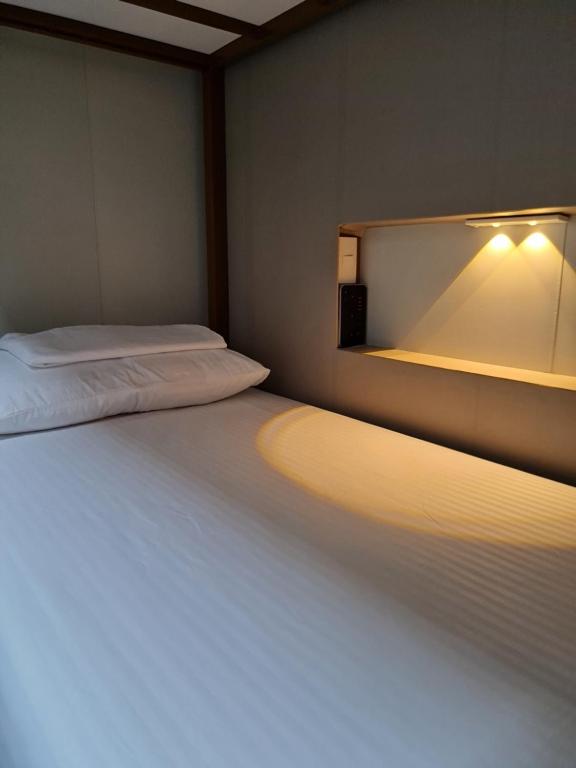 Postel nebo postele na pokoji v ubytování Ooni Hostel Moalboal