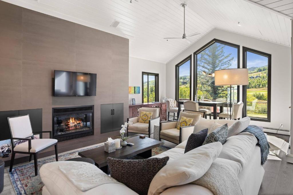 a living room with a couch and a fireplace at Homestead Townhome in Snowmass Village