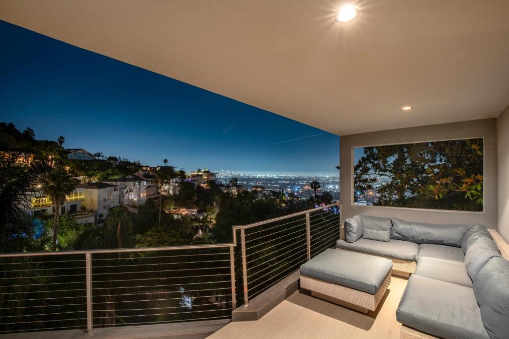 a balcony with a view of the city at night at 6MIL 5BR Sunset Strip Villa Jetliner Views Oasis in Los Angeles