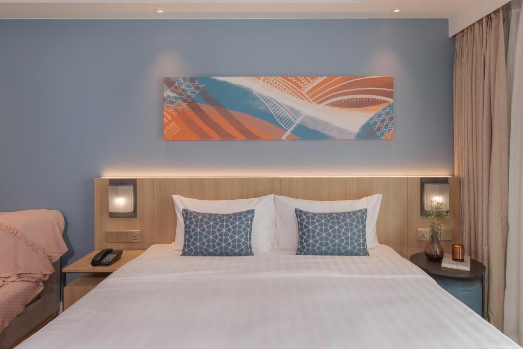 Postel nebo postele na pokoji v ubytování Citadines Roces Quezon City