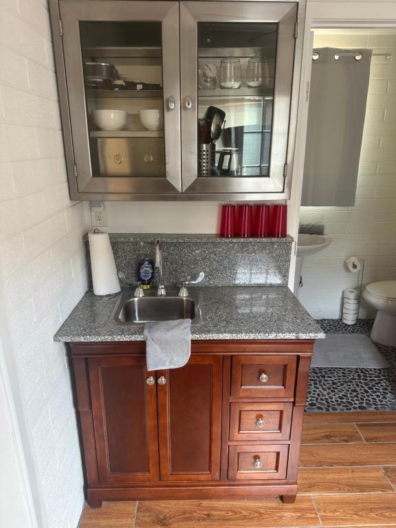 a kitchen with a sink and a counter top at Cheerful PHX Home and Guest House in Central PHX in Phoenix