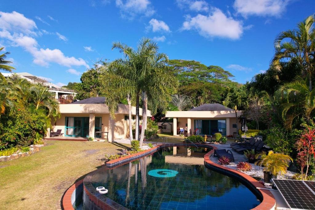 una imagen de una casa con piscina en Black Rock Villas en Rarotonga