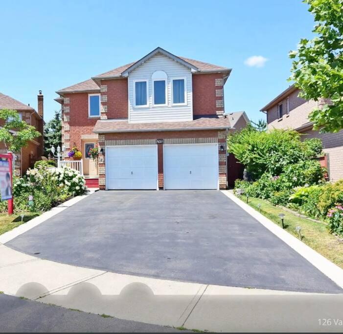 a house with a driveway in front of a house at Room for Rent Room 1 in Brampton