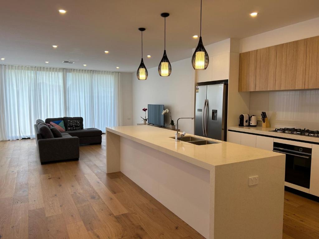 a kitchen and living room with a island in a kitchen at New 2-story house with 4 bedrooms and 3 shower rooms in Burwood