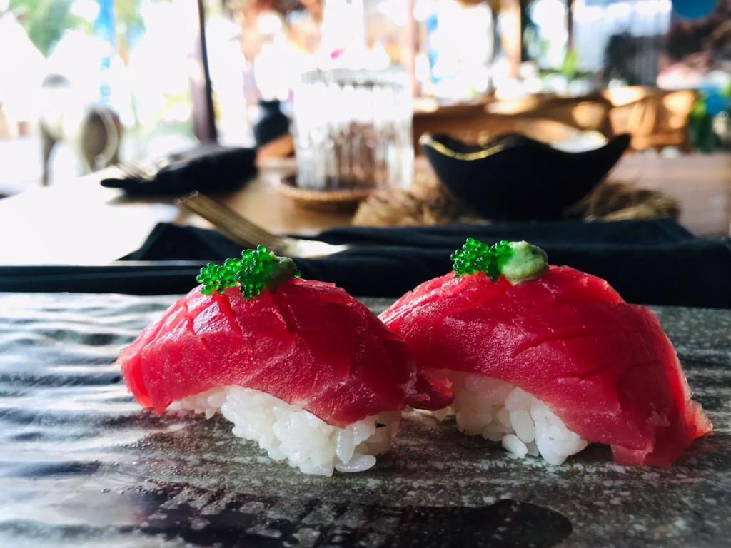 dos piezas de sushi sentadas sobre una mesa en Hakuna Matata Resort Gili Air, en Gili Air