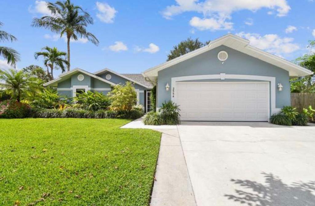 a house with a garage in a yard at Florida house, 4br 2bt with private pool oasis in Naples
