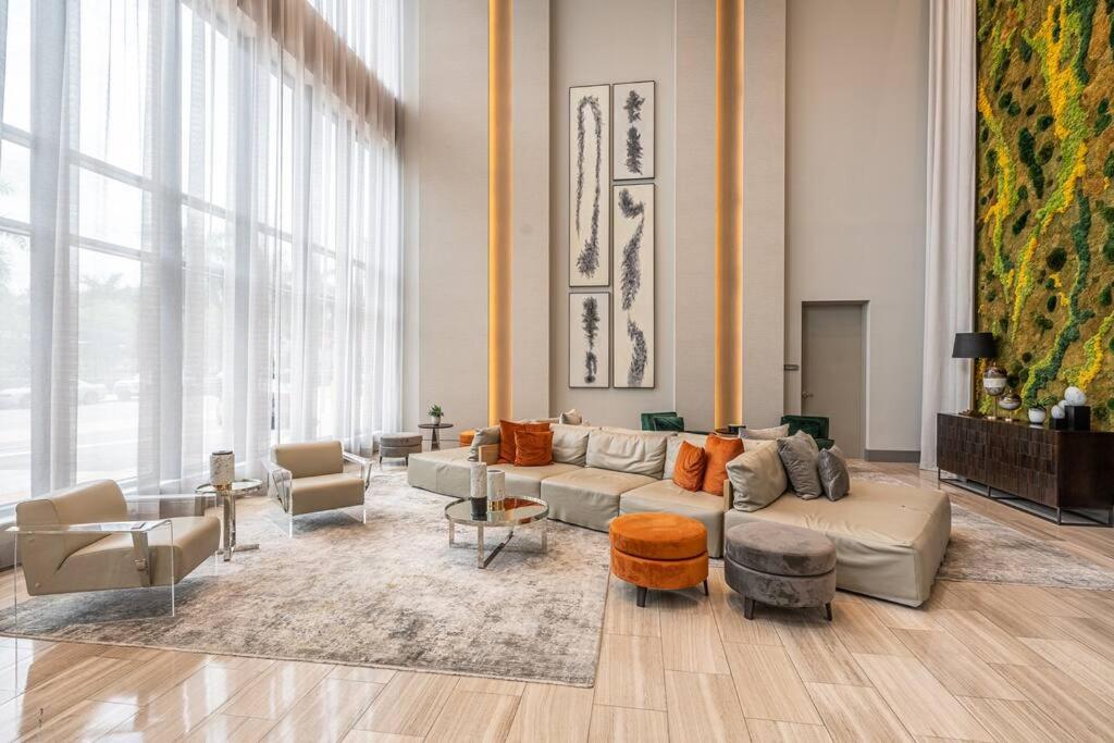 a living room with a couch and chairs at Stunning Apartment in Downtown Doral in Miami
