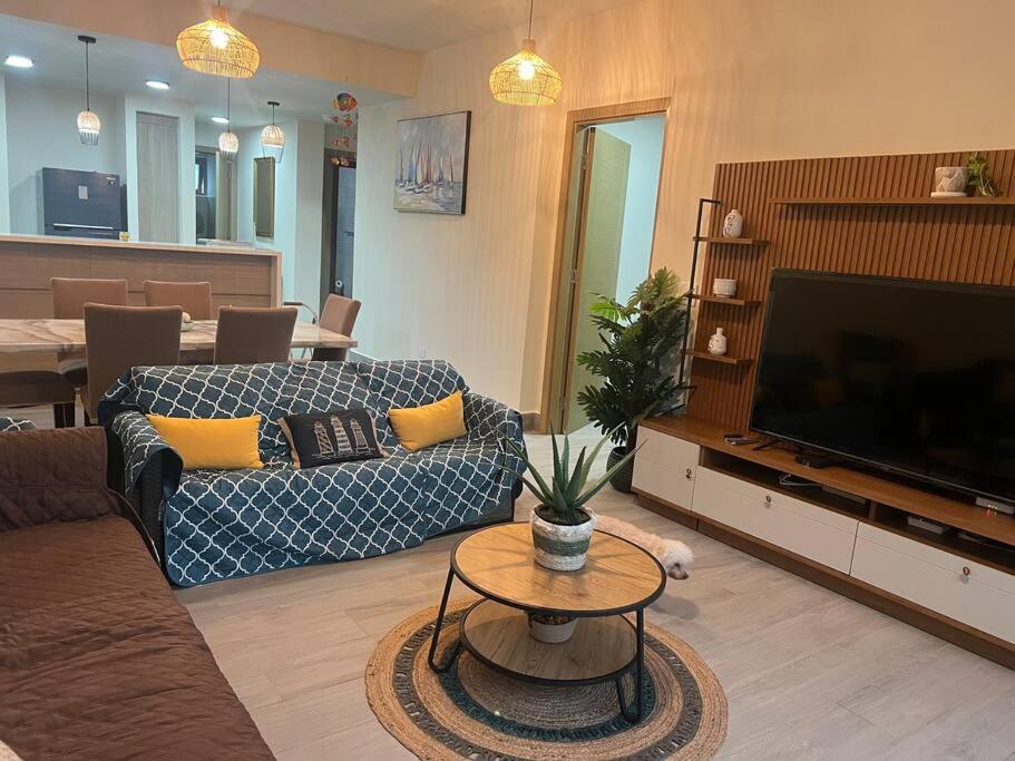 a living room with a couch and a flat screen tv at Lagoon Village, Playa Escondida in Colón