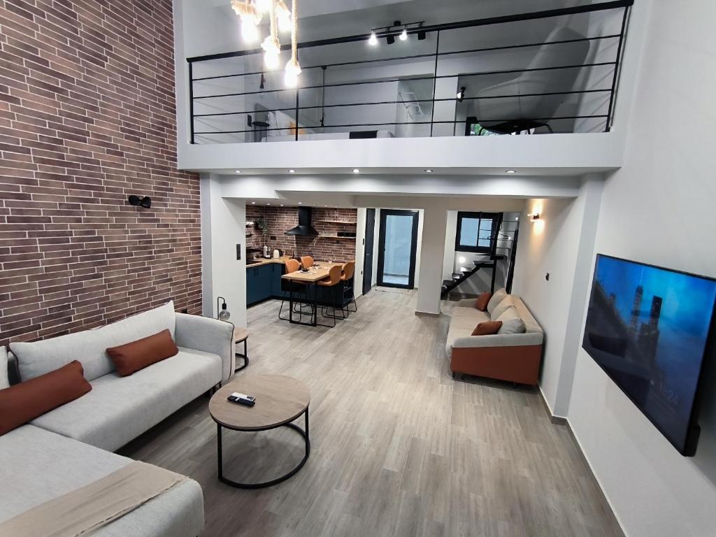 a living room with a couch and a table at ZOE LOFT in Kavála