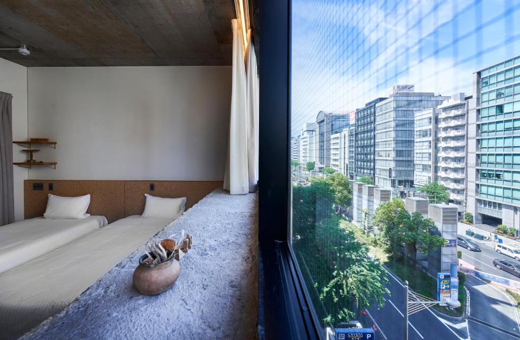 Postel nebo postele na pokoji v ubytování Hotel Morning Box Osaka Shinsaibashi