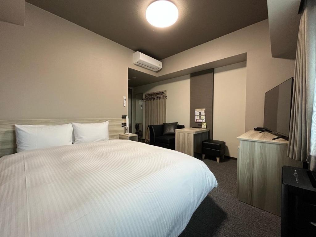 Postel nebo postele na pokoji v ubytování Hotel Route Inn Numata