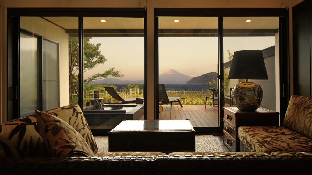 a living room with a couch and a table at Fugaku Gunjo in Izu